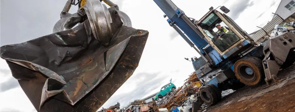 digger sorting scrap metal